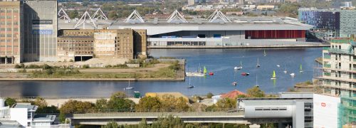 Scene of Royal Victoria Dock from the south, with water, houses and ExCeL centre