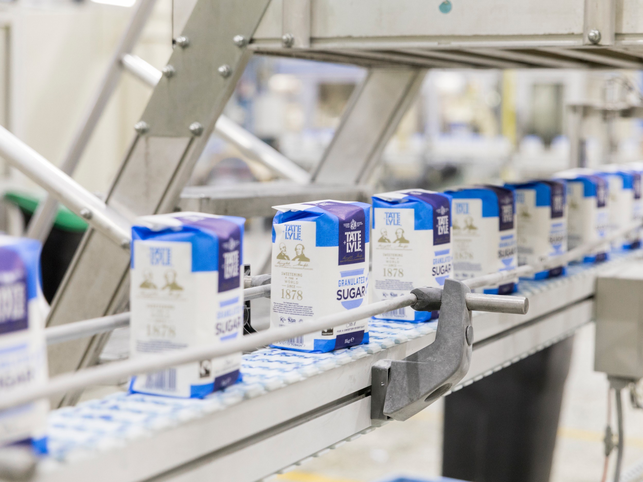Bags of sugar on an assembly line