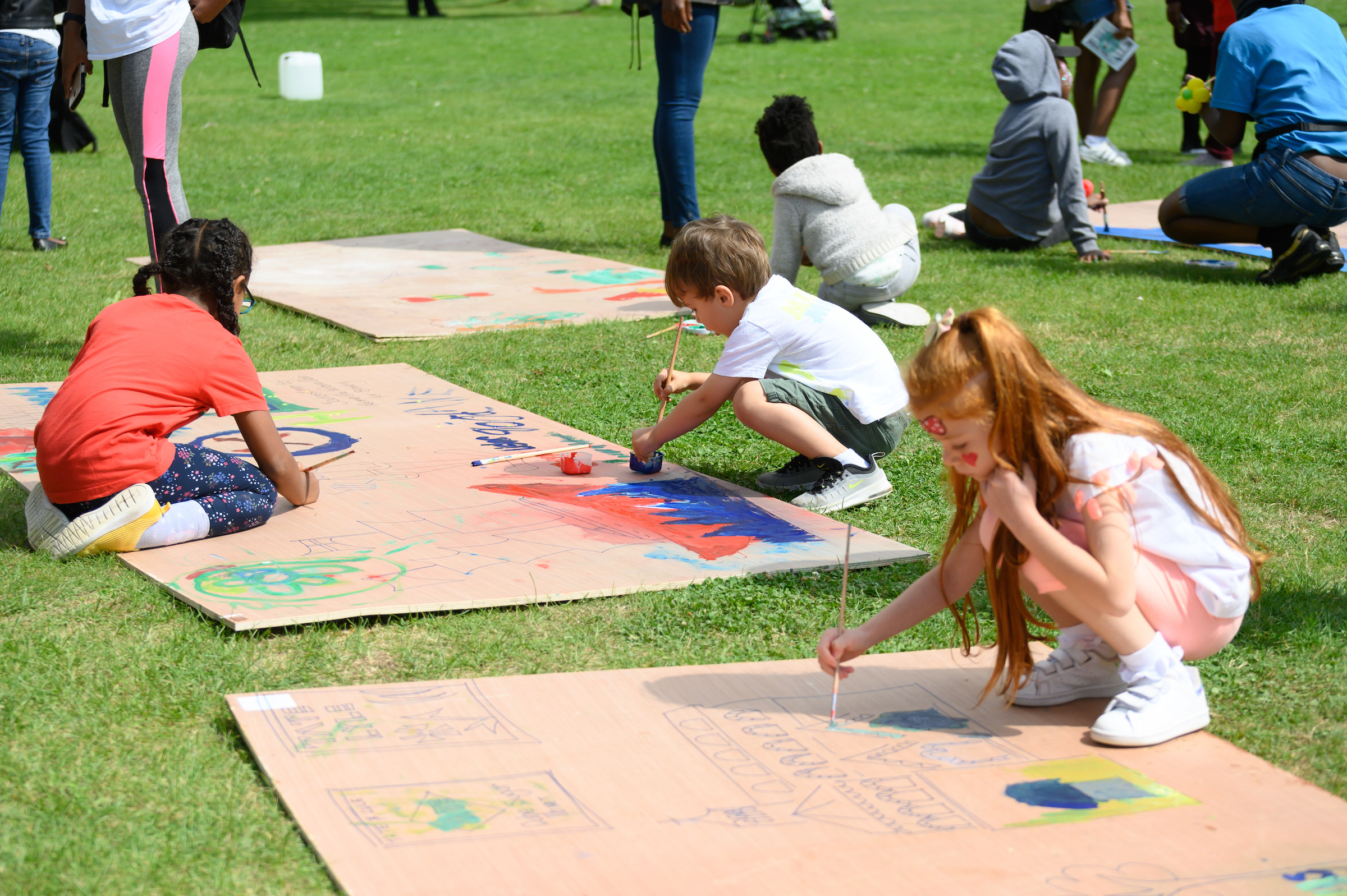 Children painting on boards