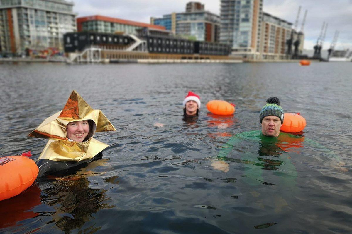 Swimmers in costume in the dock waters