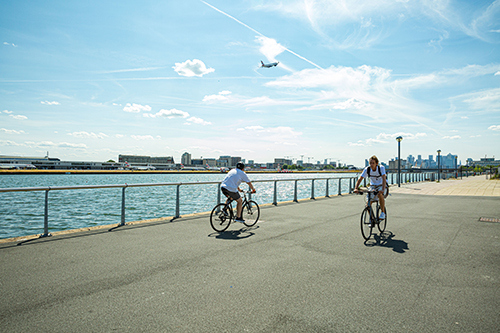 Two men cycling along the Royal Docks