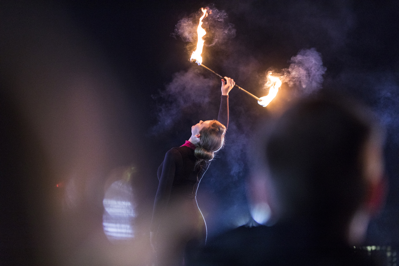 Dancer holding stick with flames at either end