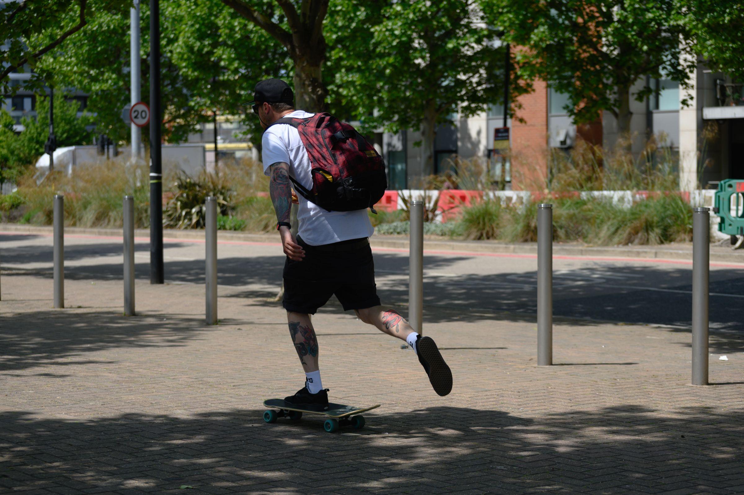 Man riding on a skateboard near the Royal Docks