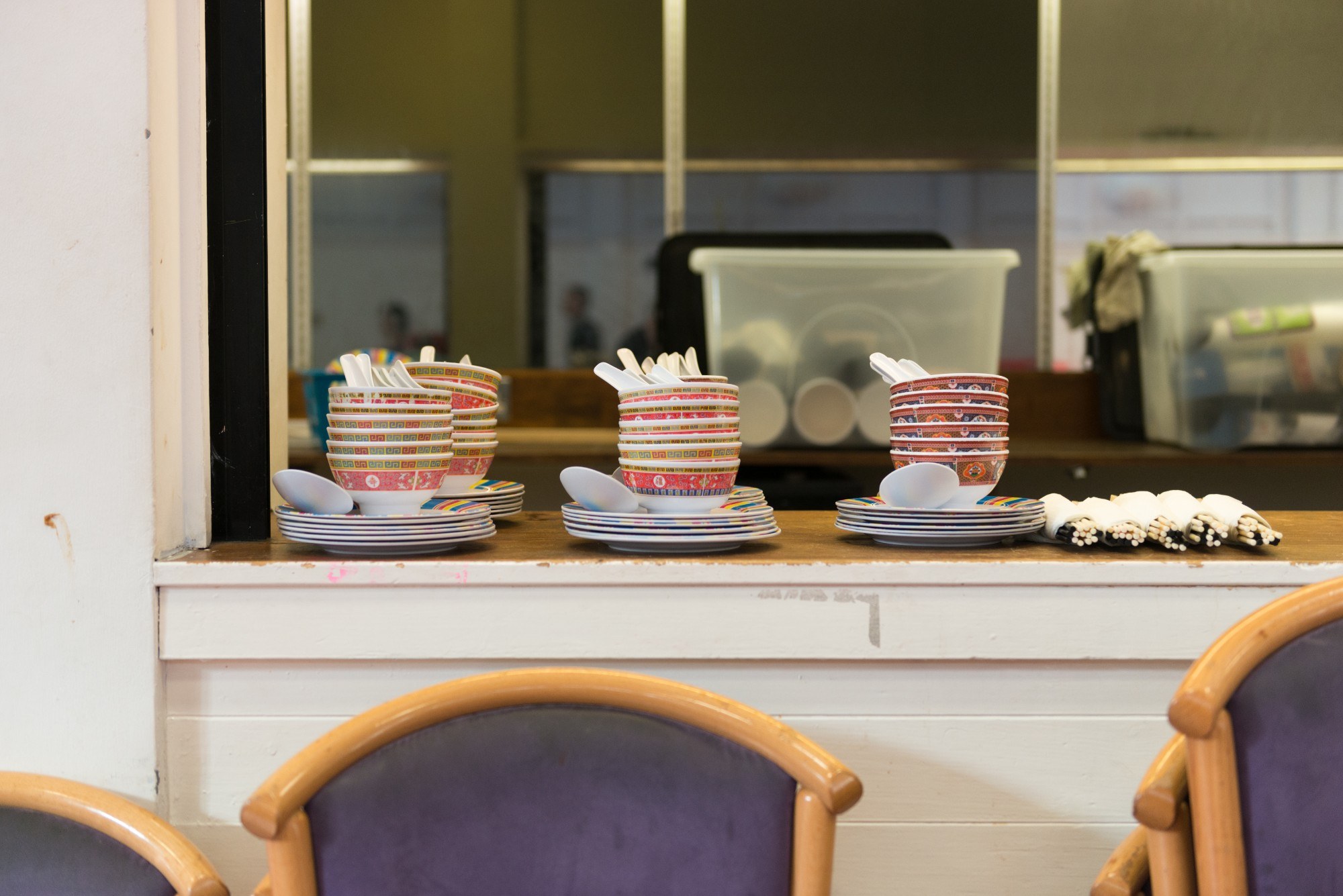 Piles of bowls lined up on a counter