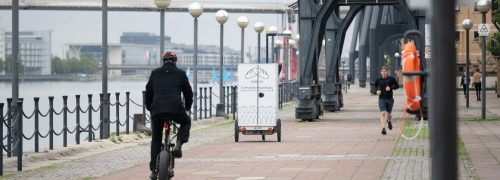 Loafly's white delivery bike seen driving off along the dockside