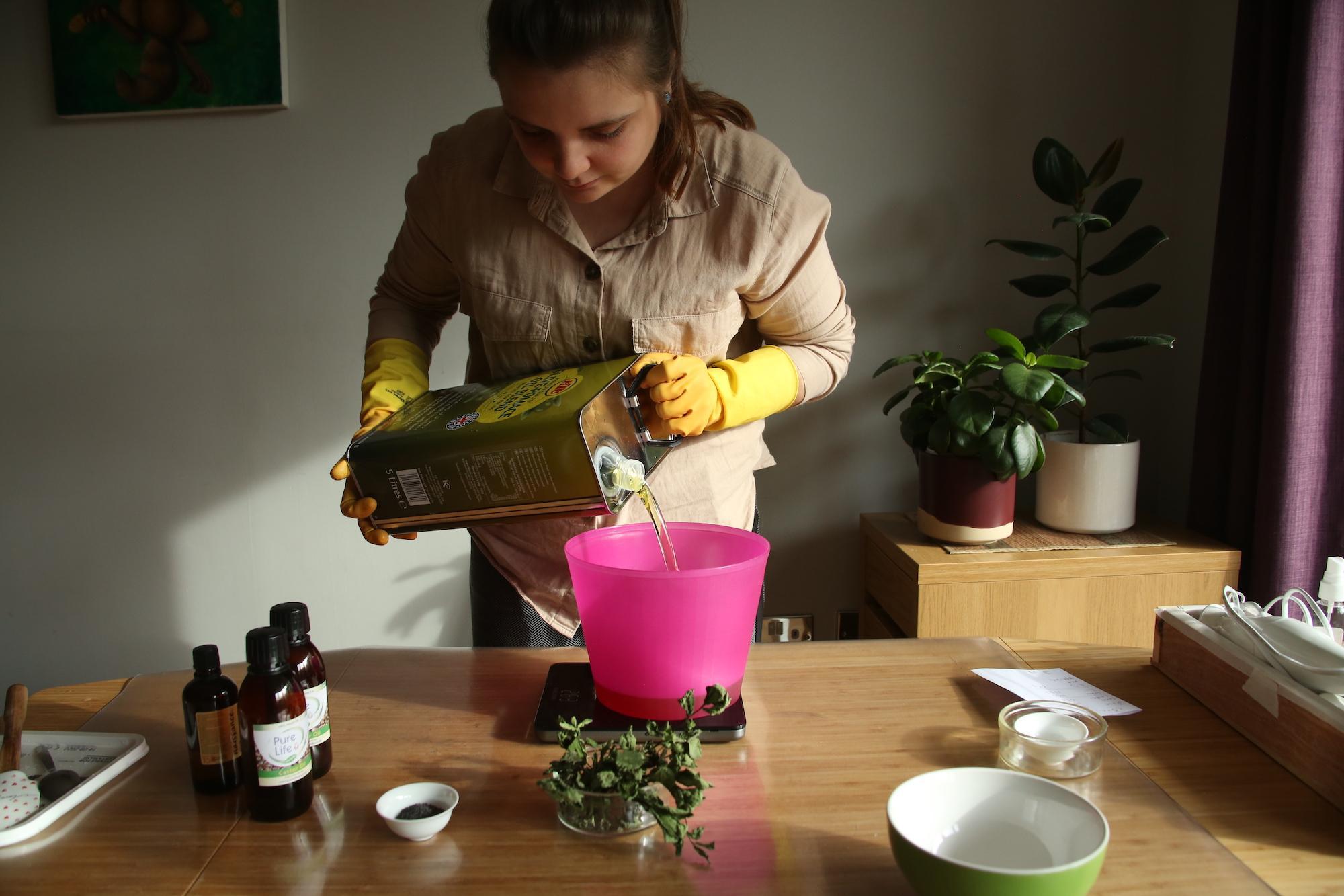 Nadia pouring soap ingredients into a bowl