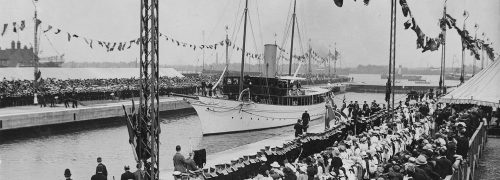 A historical photo of boats and crowds at the Royal Docks