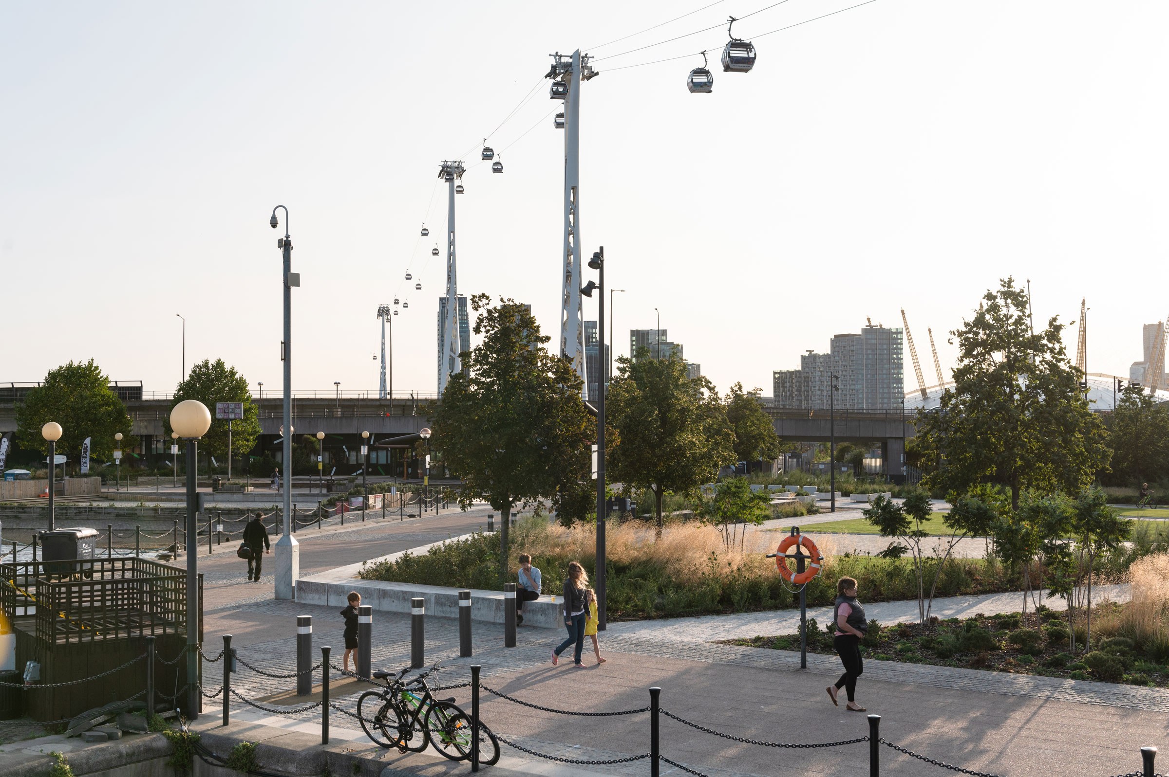 Scenic view of Royal Victoria Docks with people and cable cars overhead