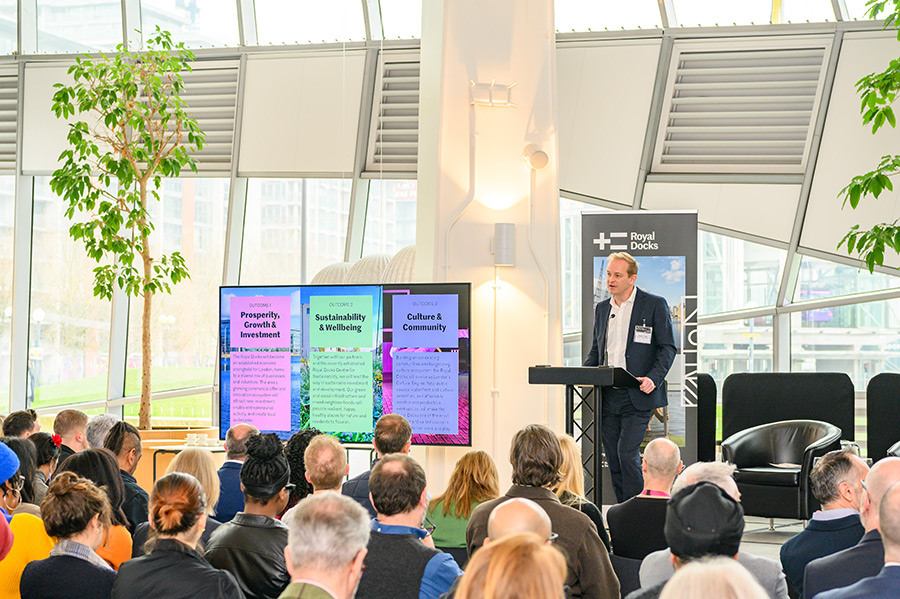 Dan Bridge speaking to a large crowd in City Hall at the launch of the Royal Docks Delivery Plan