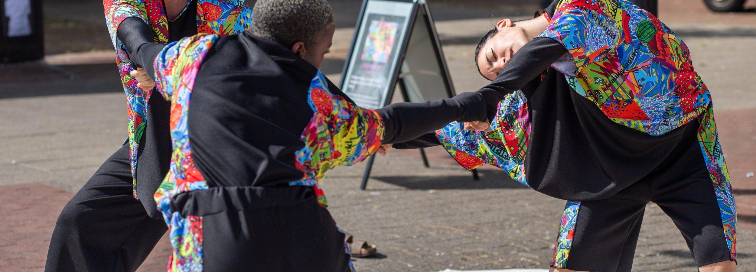 Two women dancing at Queens' Roar event