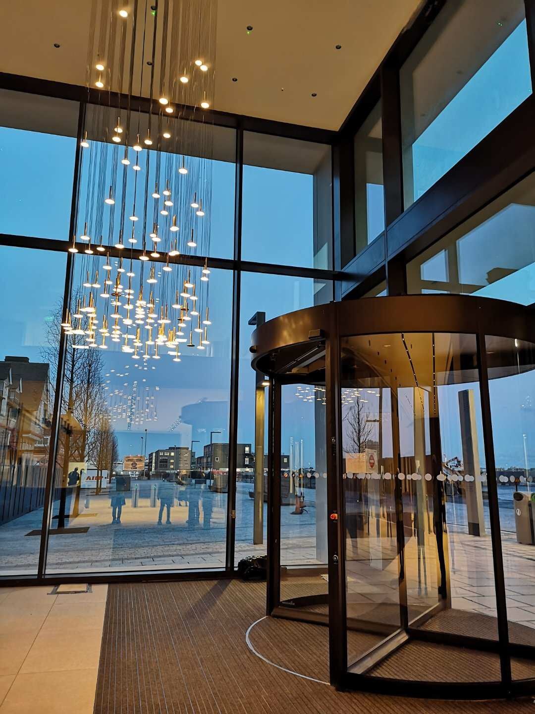 A building entrance with revolving doors on the banks of the Royal Albert Dock