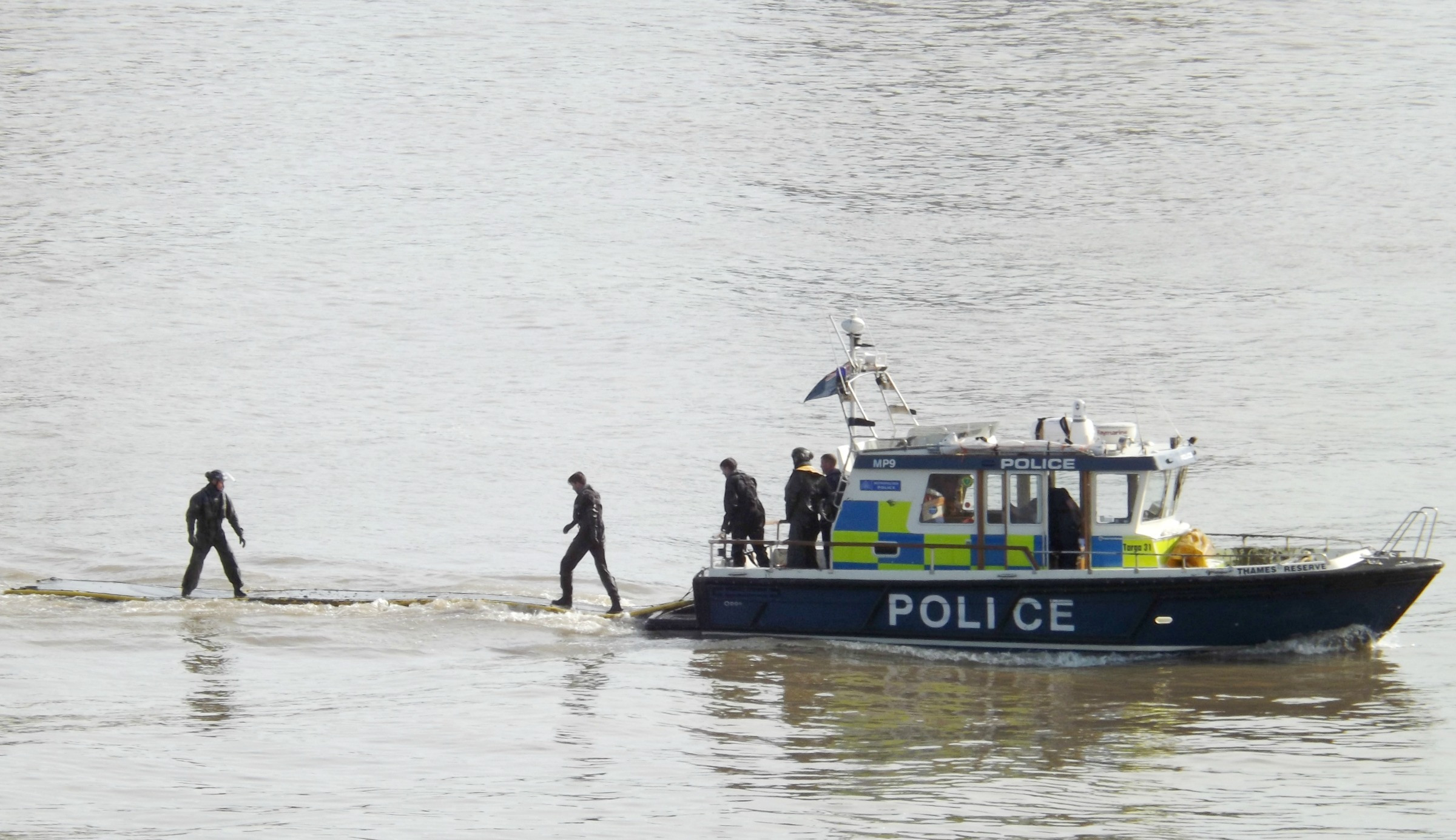 Metropolitan police practicing with their floating mud rescue mats