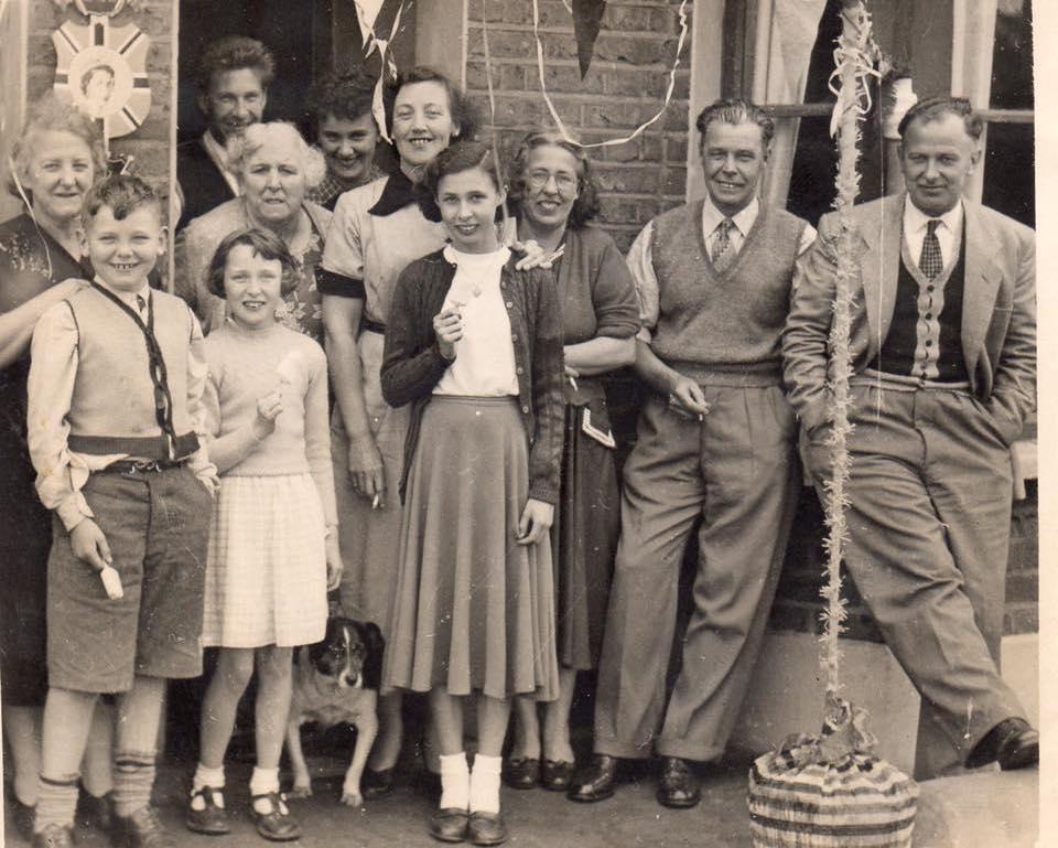 Nicely dressed royal docks locals lined up to celebrate queen elizabeth's coronation