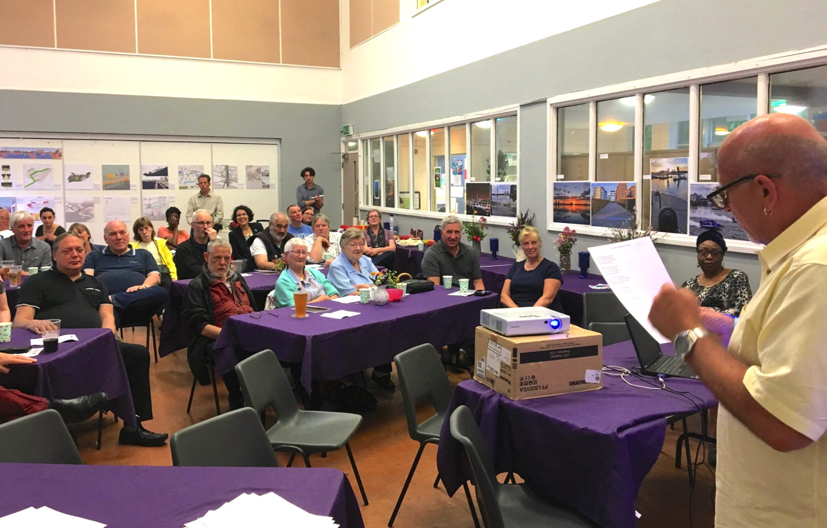 photo from a history club meeting with people watching a performer