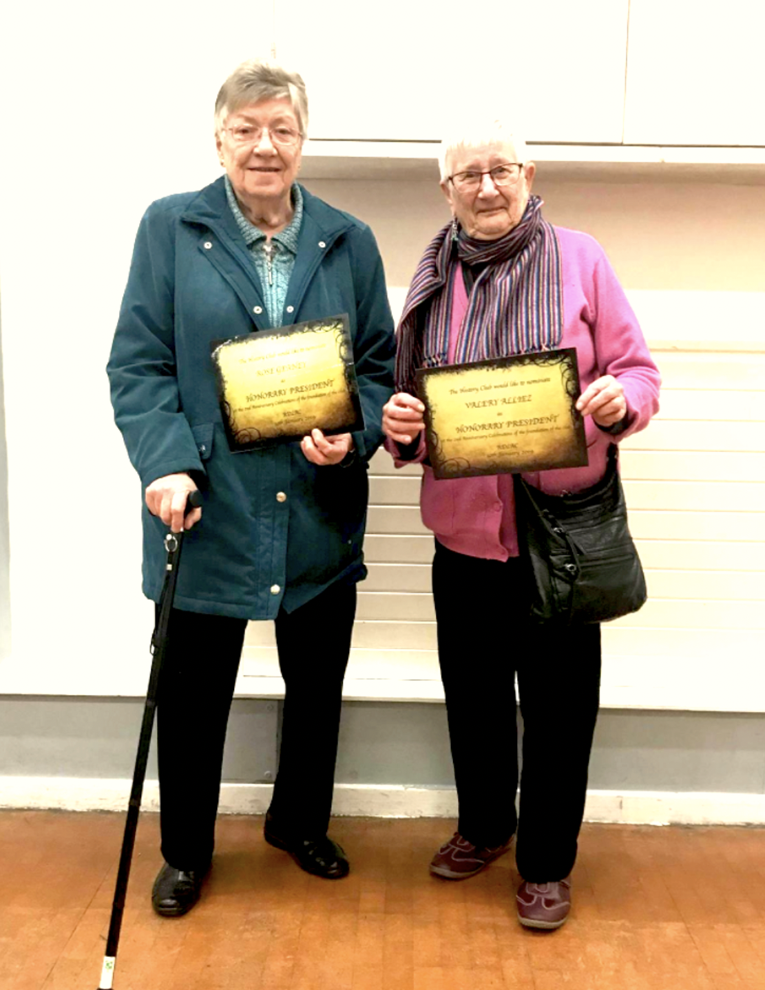 rose and valery standing side by side holding diplomas