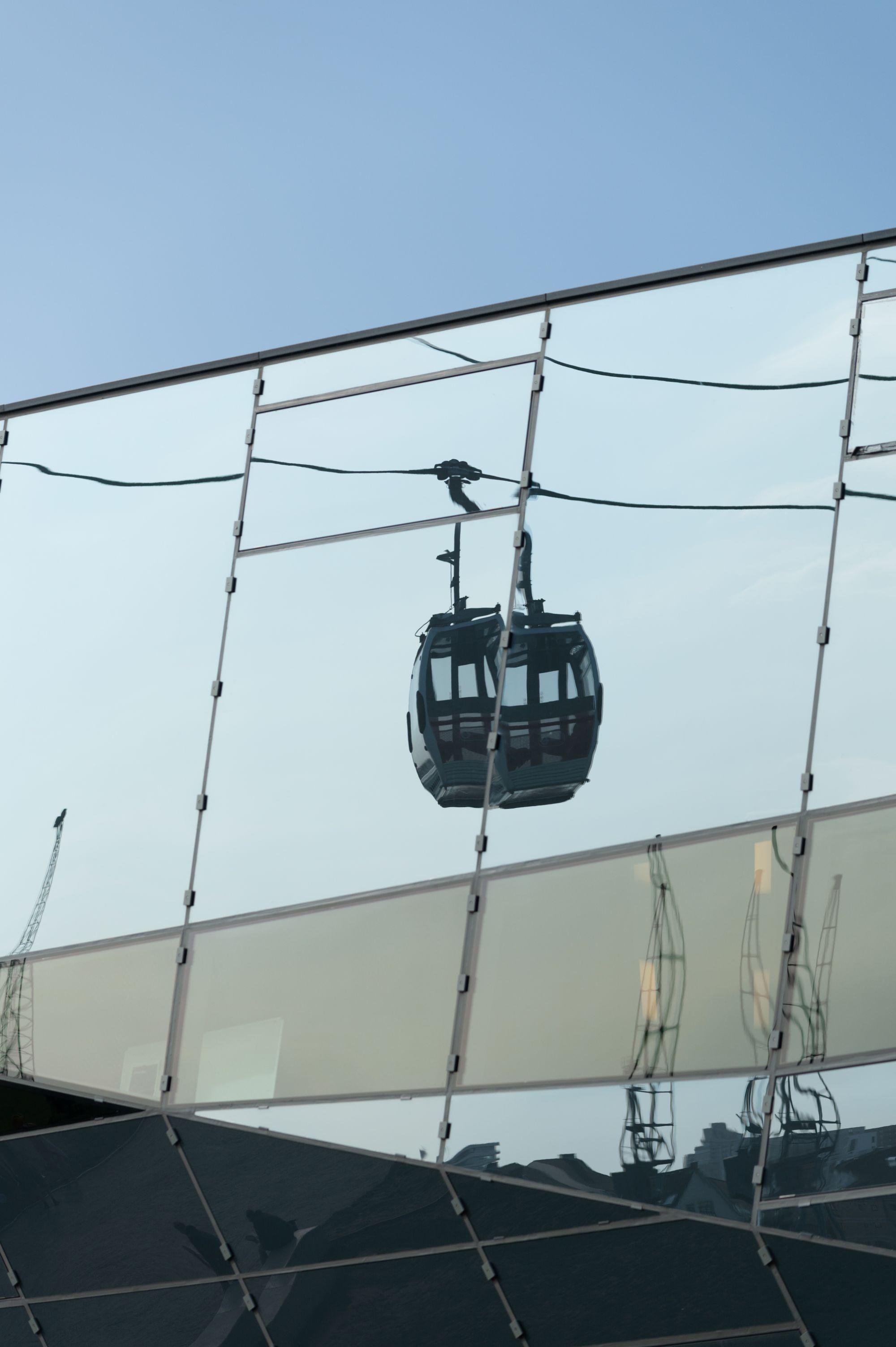 A cable car reflected in a glass wall