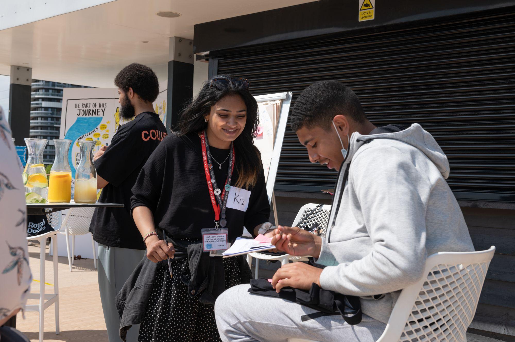 Youth network members talking and writing during workshop